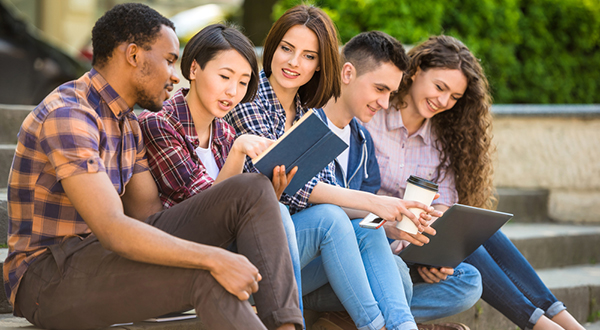 Image of four university students sitting on steps