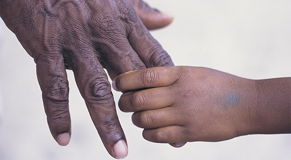 Image of a child's hand holding an adult's hand